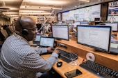 man in black and white checkered dress shirt using computer