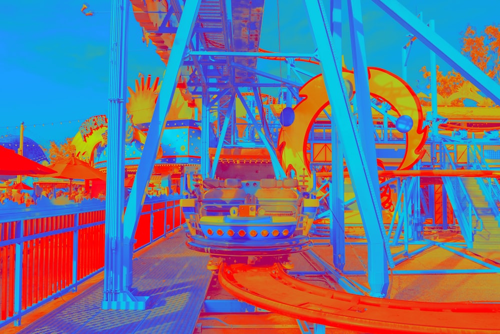 blue and red amusement park ride during daytime