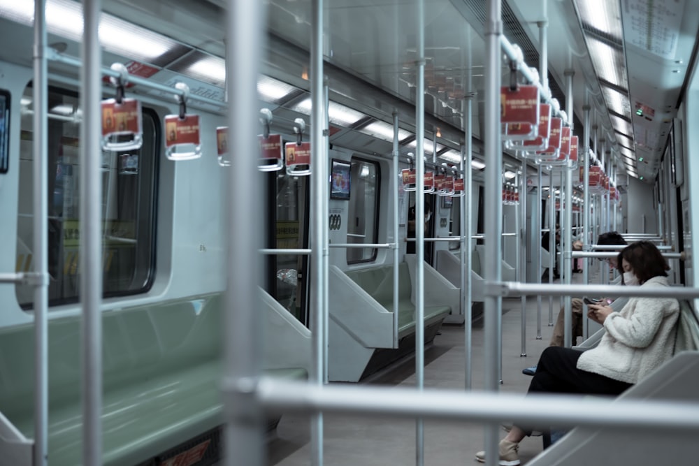 person in black jacket sitting on train seat