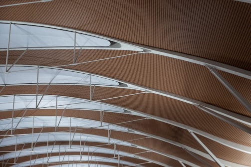 Modern ceiling with PVC panels and louvres creating a dynamic, airy space.