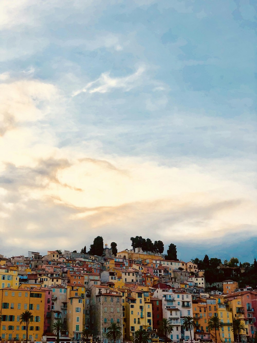 city buildings under white clouds during daytime