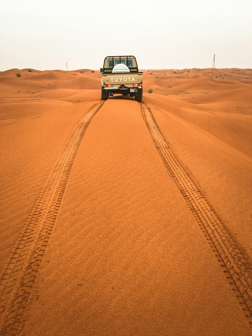 white suv on brown sand