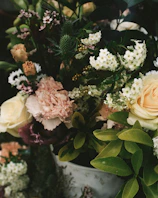 Colorful mix of roses, mini carnations, and delicate gypsophila in a fresh floral bouquet.