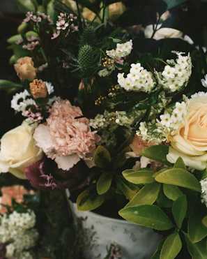 Colorful mix of roses, mini carnations, and delicate gypsophila in a fresh floral bouquet.