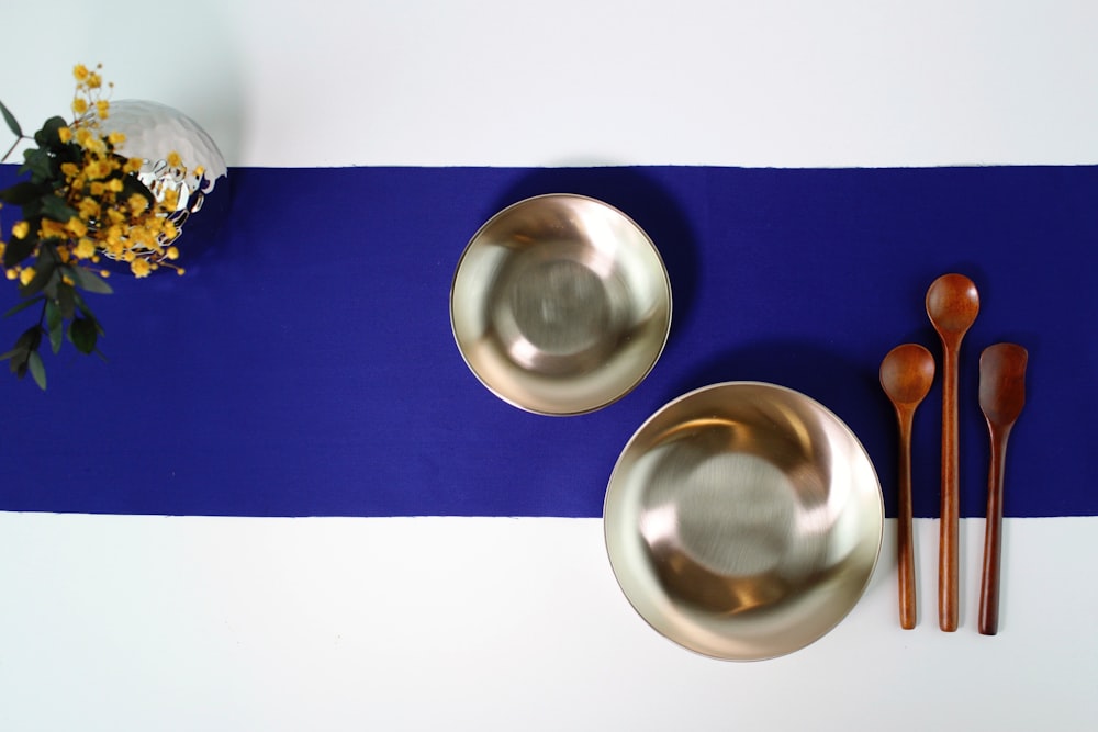 stainless steel round bowl on blue table