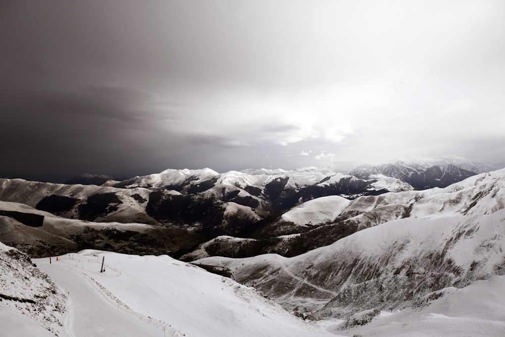 snow covered mountain under cloudy sky during daytime