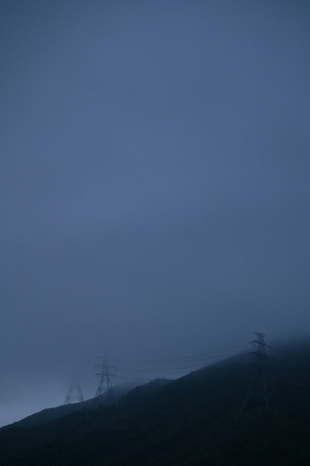 silhouette of mountain under gray sky