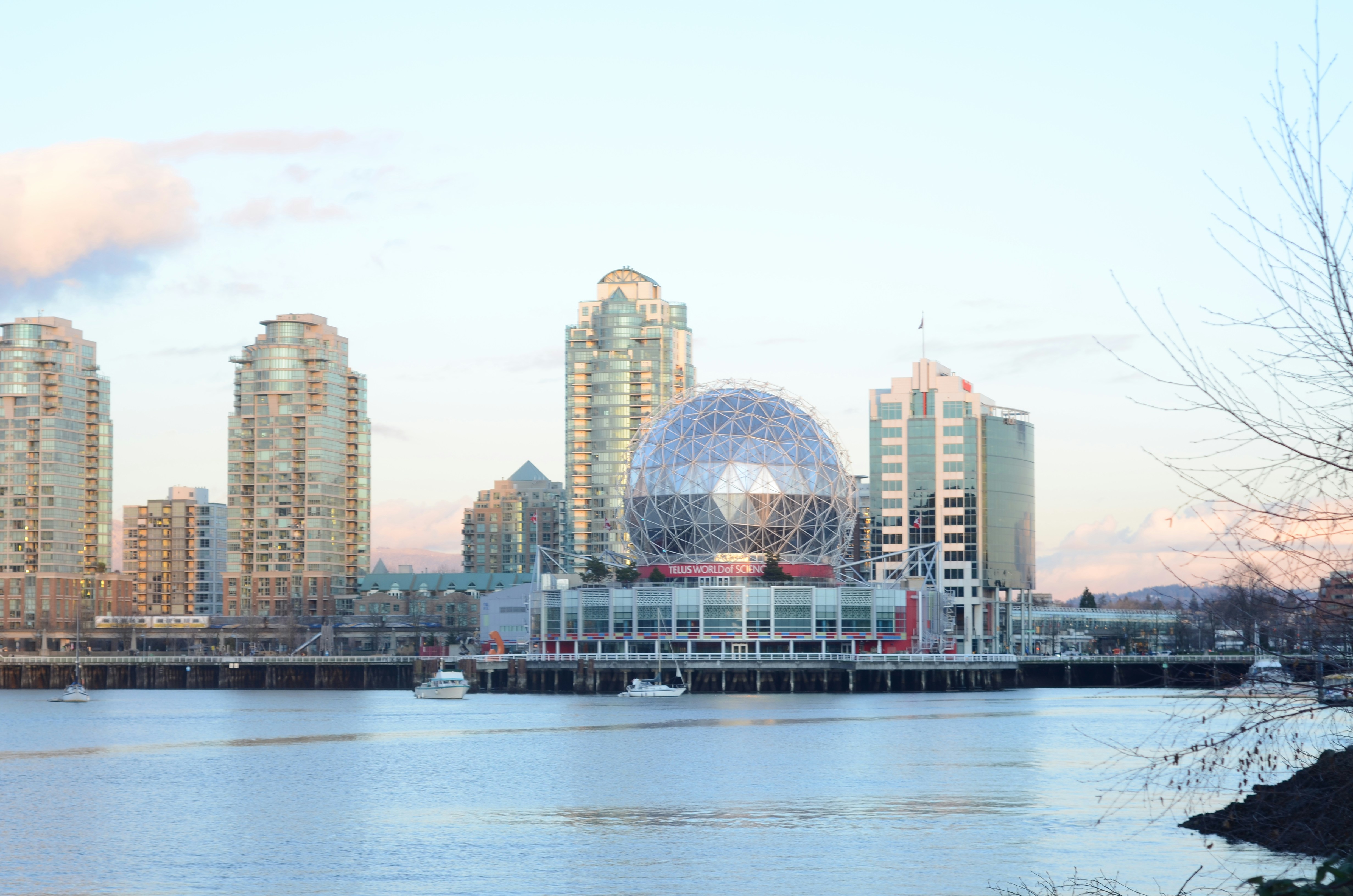 Vancouver Telus world of science / science world in the sun with four modern buildings in the back