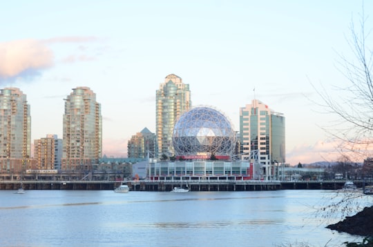 city skyline across body of water during daytime in Science World Canada