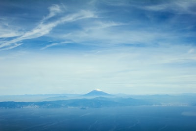 aerial view of mountains under blue sky during daytime magnificent teams background