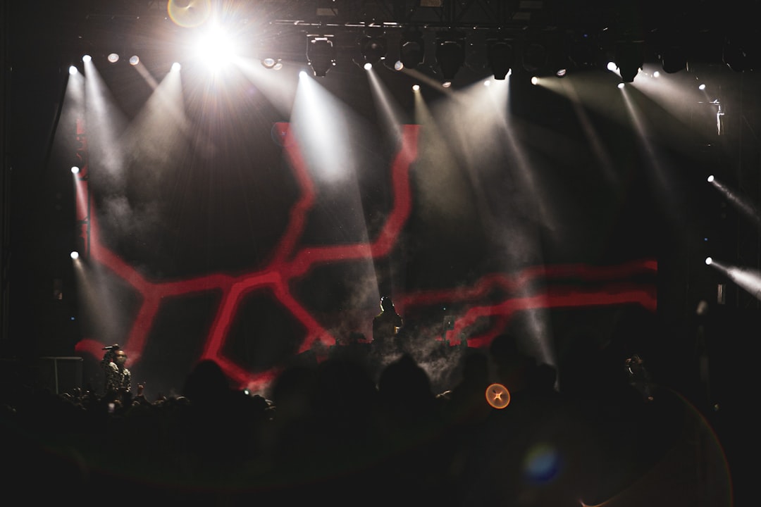 people standing on stage with lights