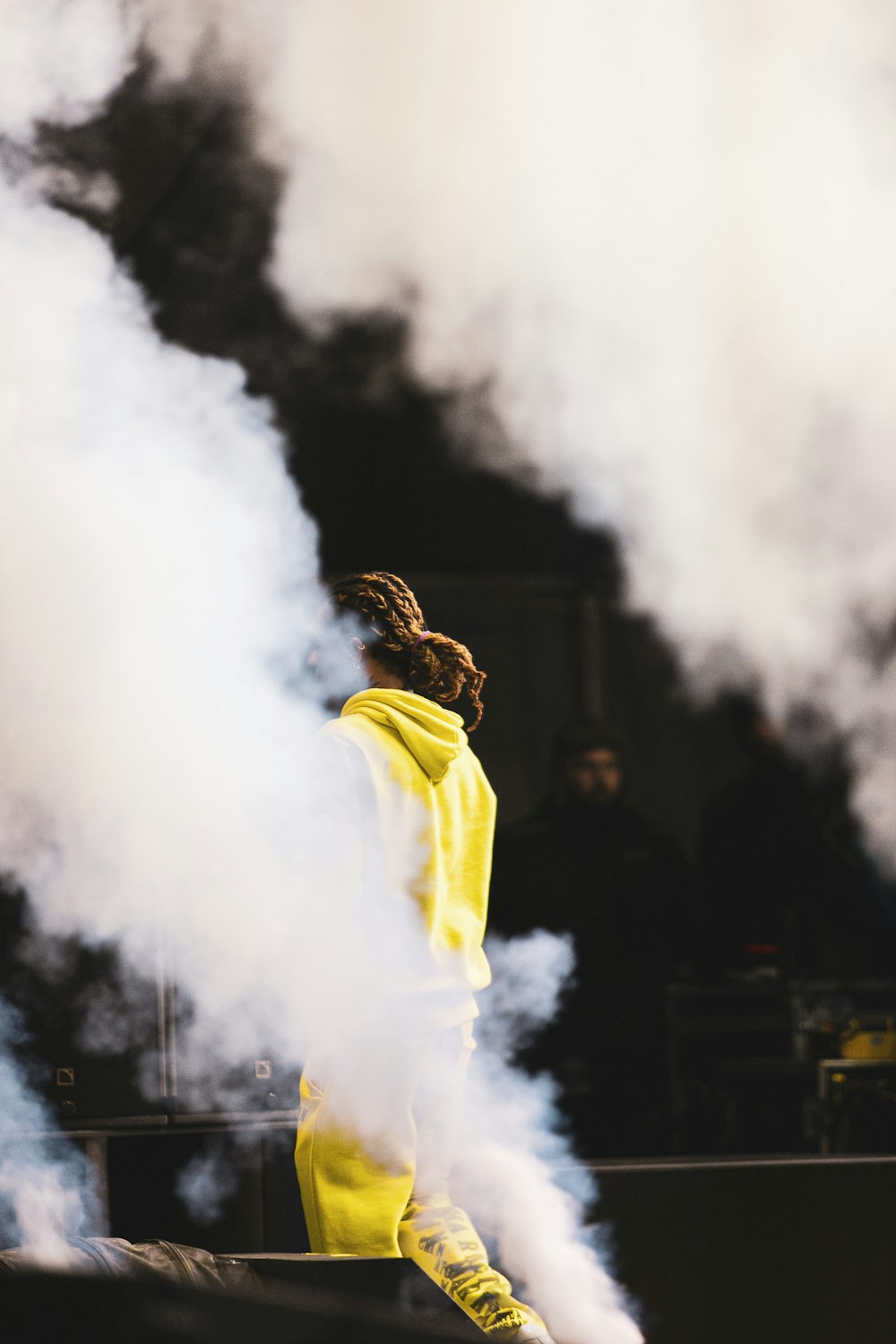 man in yellow hoodie smoking