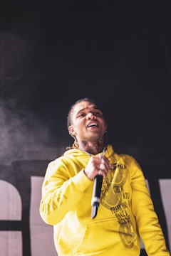 Model wearing a skytune hoodie with a bold rock stage graphic.