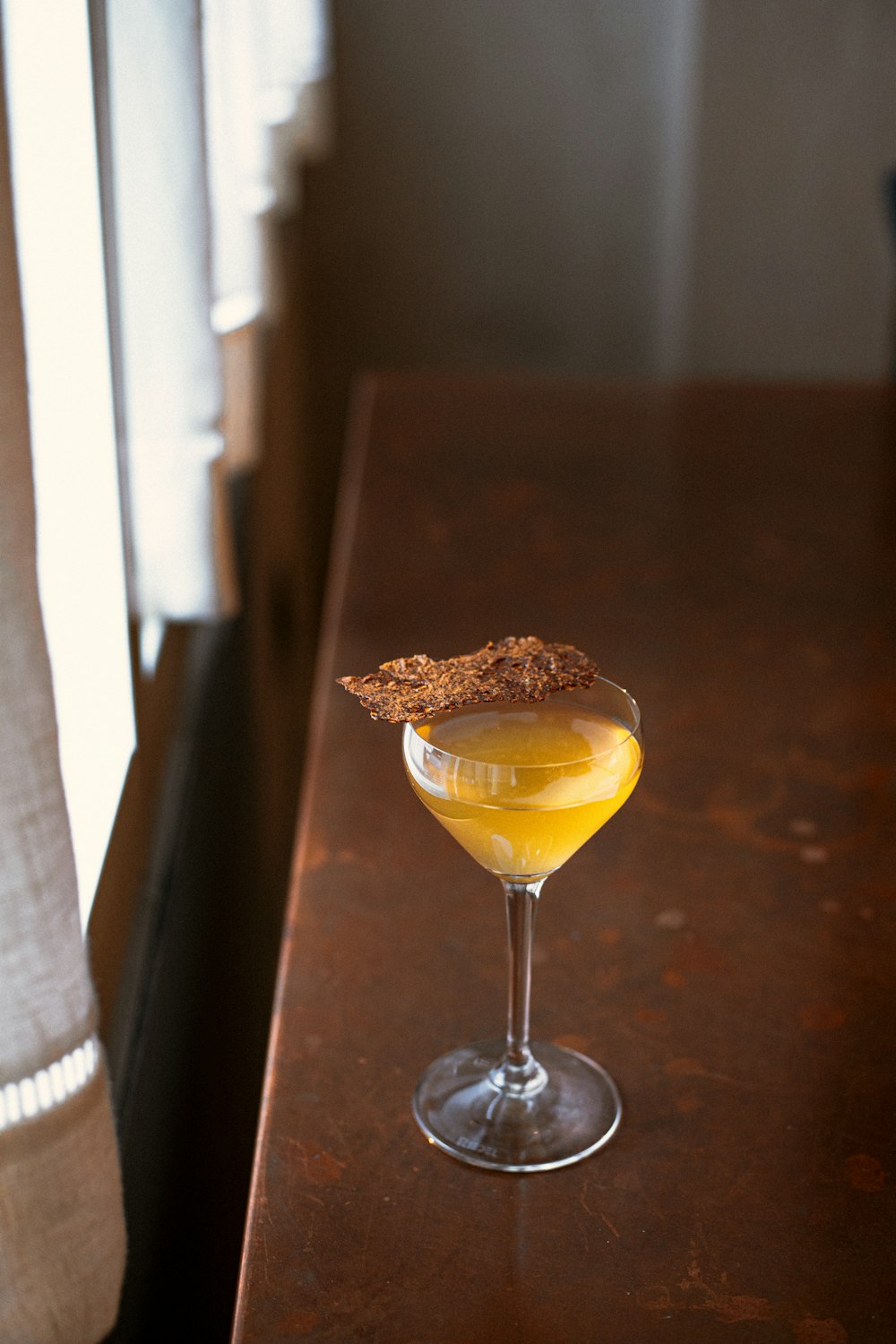 clear wine glass with yellow liquid