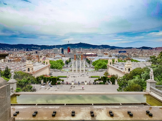 white concrete building under blue sky during daytime in The Magic Fountain Spain