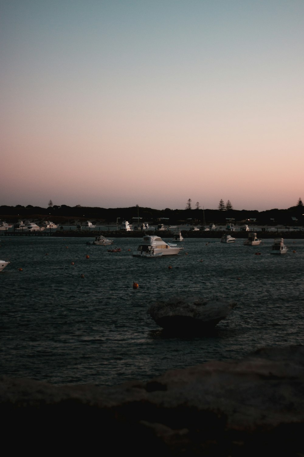 white boats on sea during daytime