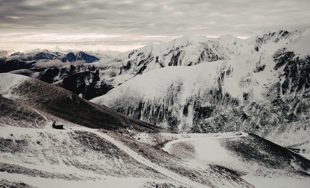 snow covered mountain under white cloudy sky during daytime