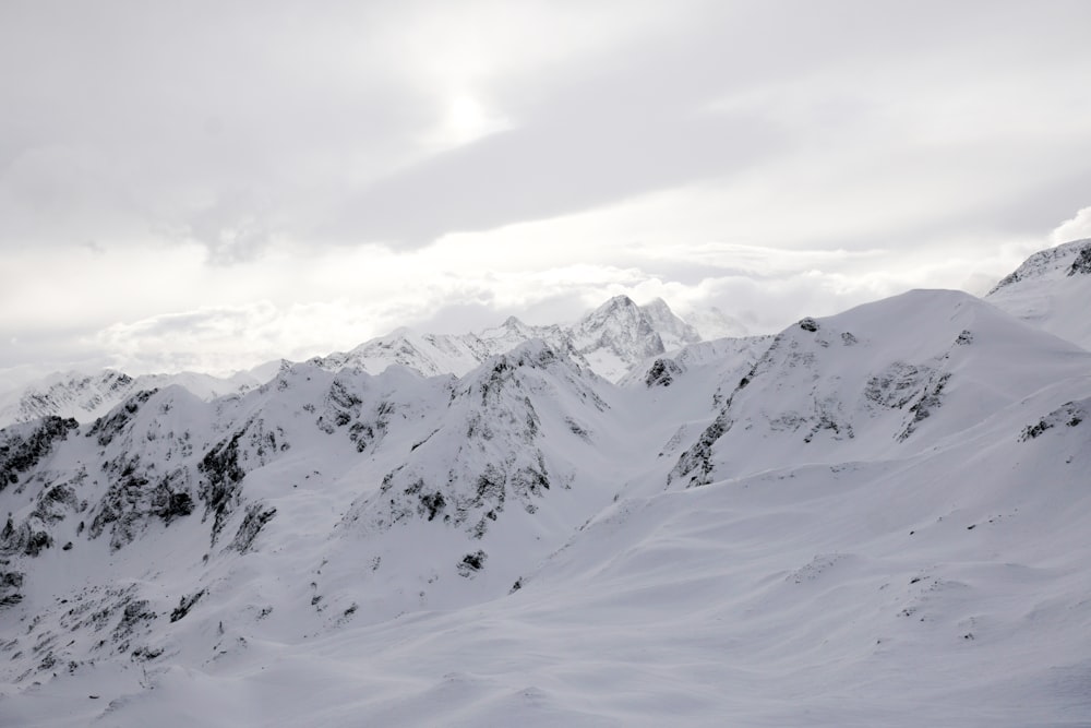 snow covered mountain under cloudy sky during daytime