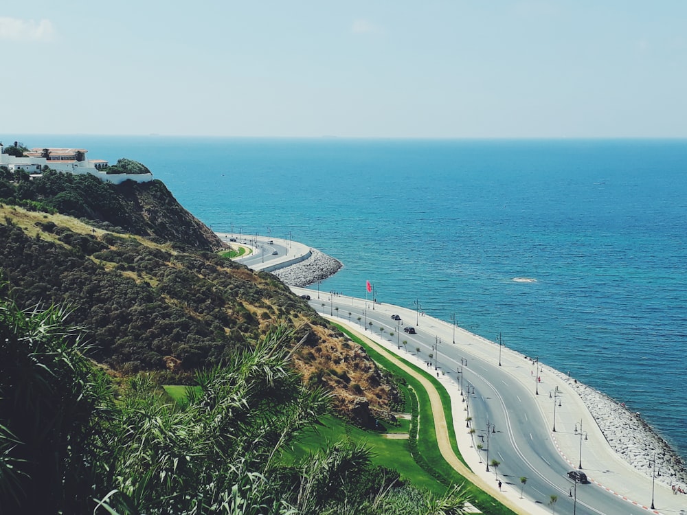 Coches en carretera cerca del mar durante el día