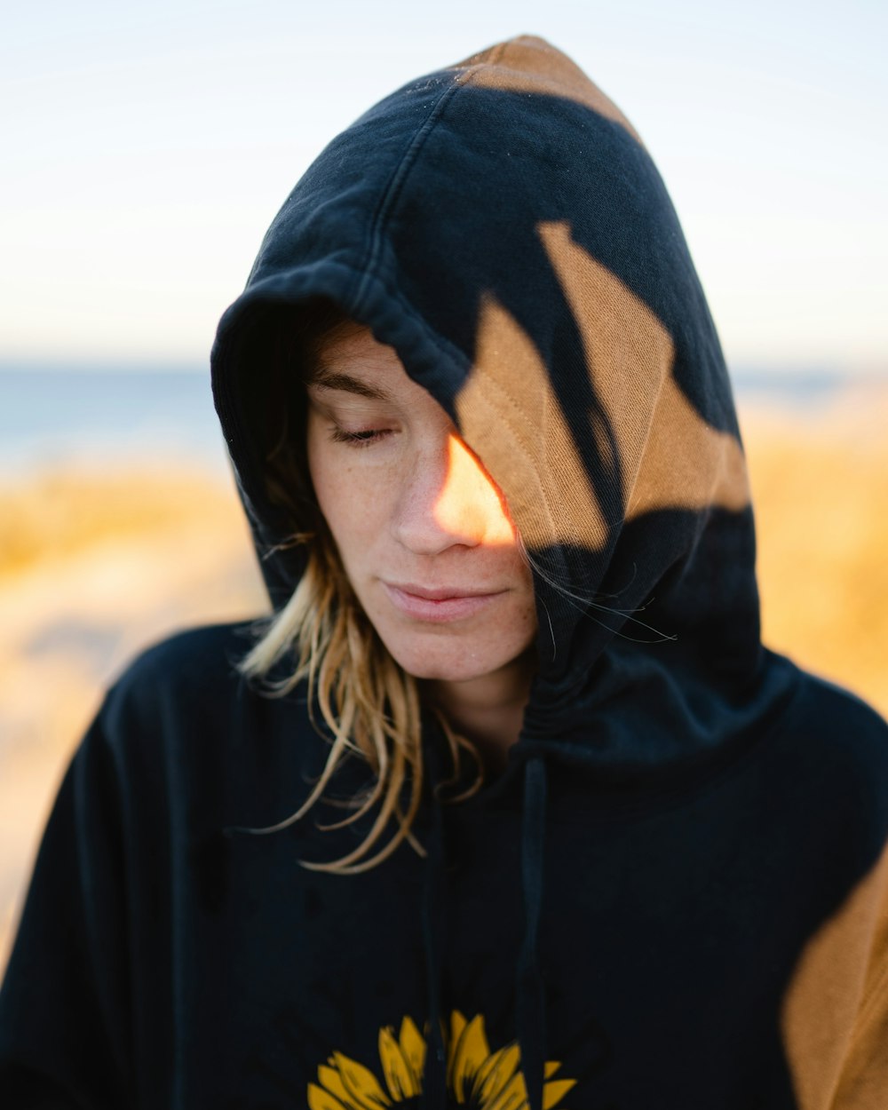 woman in black hoodie standing during daytime