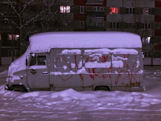 white and purple van on snow covered ground
