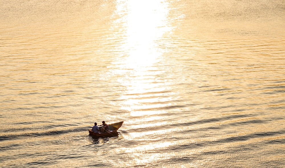 man in black shirt riding on boat on sea during daytime