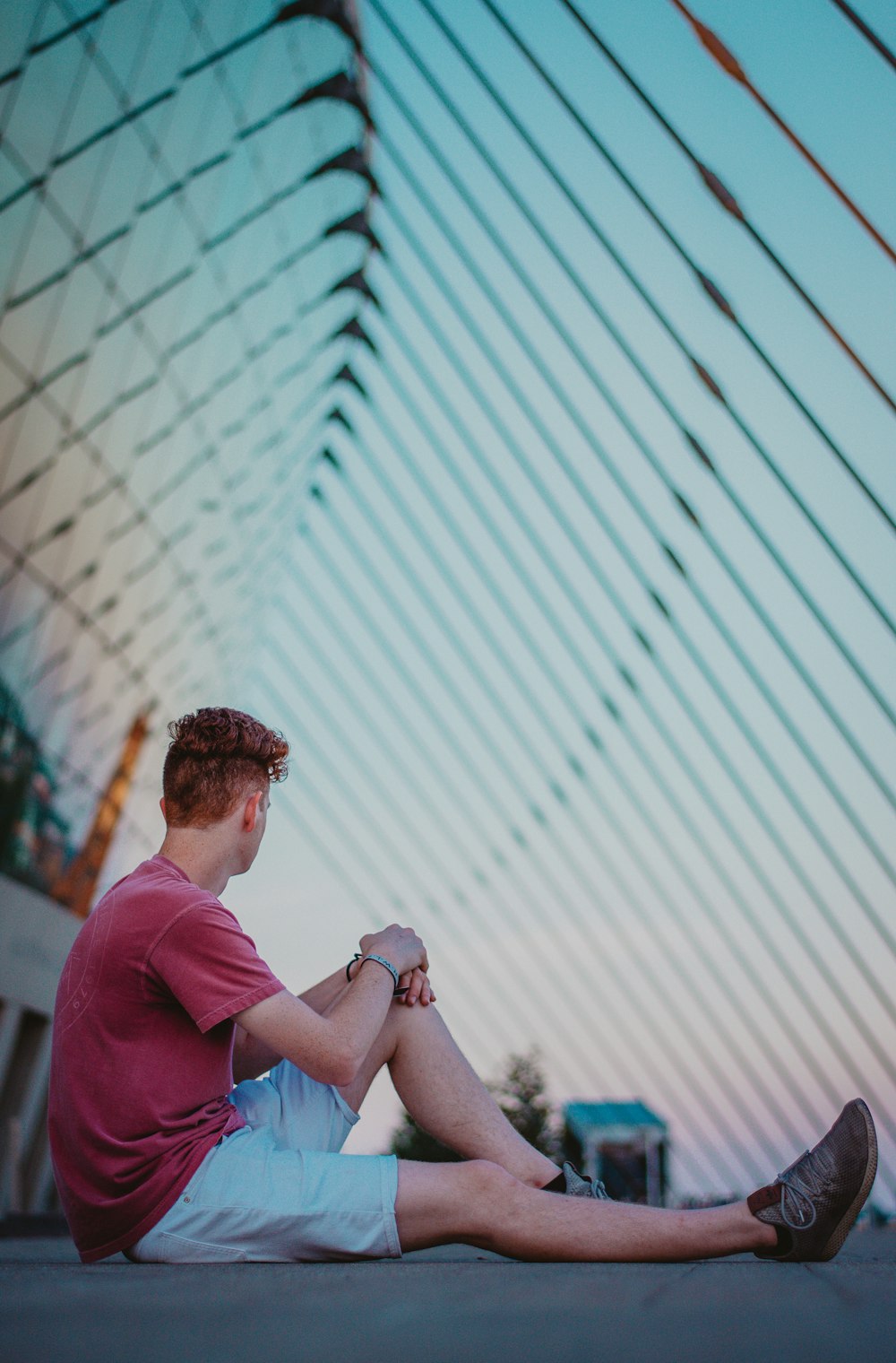 man in red polo shirt holding white smartphone