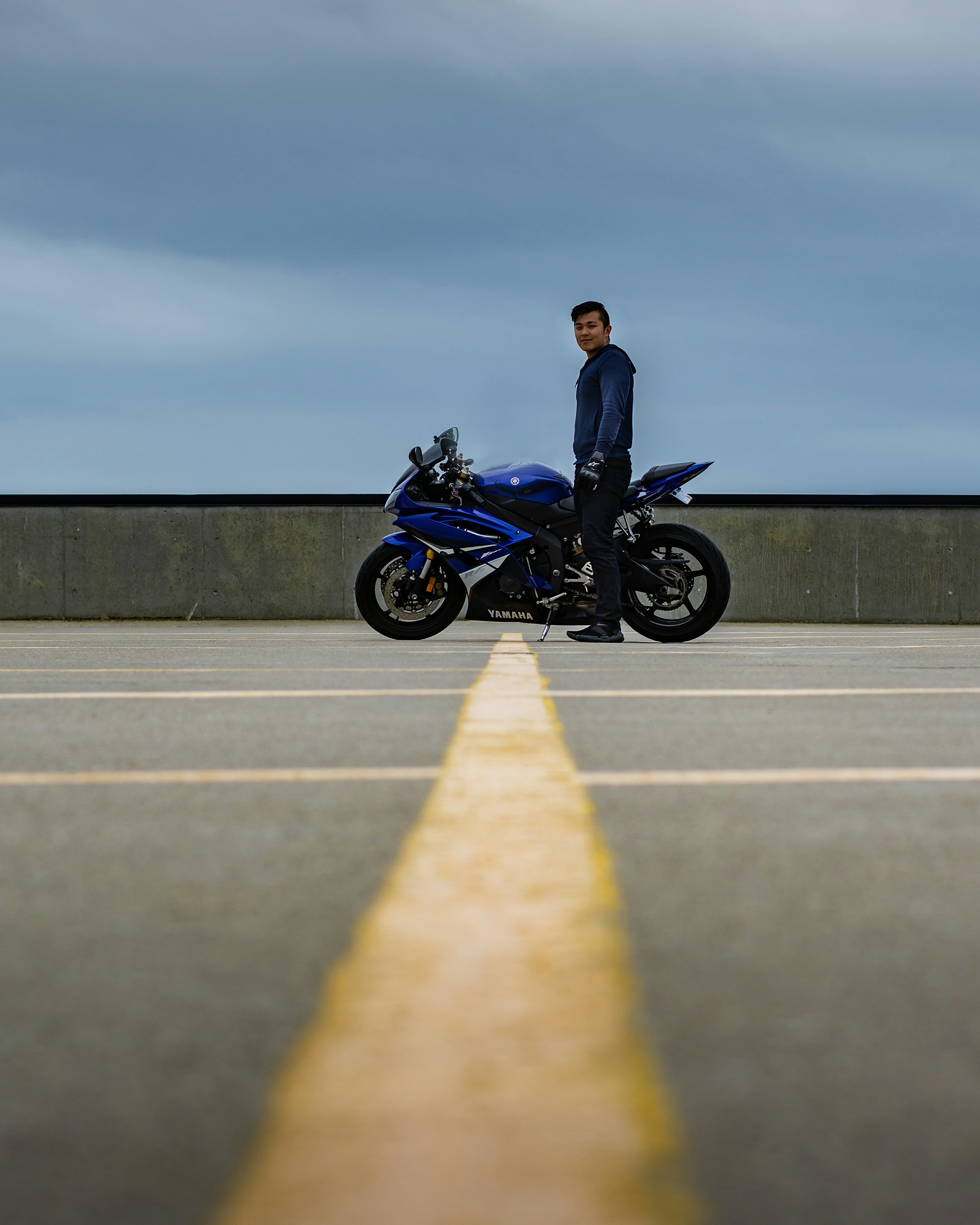 man in black jacket riding black motorcycle on road during daytime