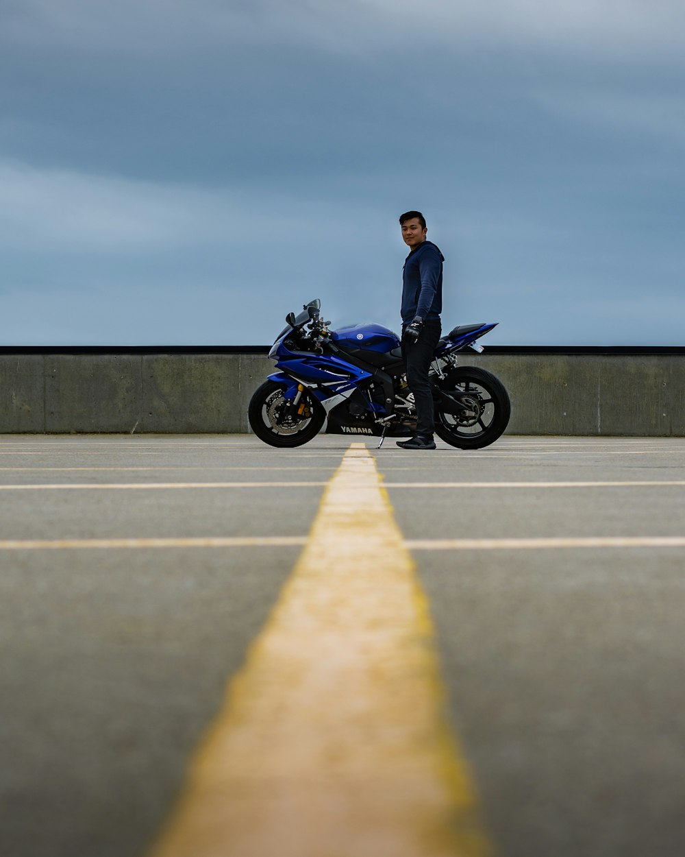 man in black jacket riding black motorcycle on road during daytime