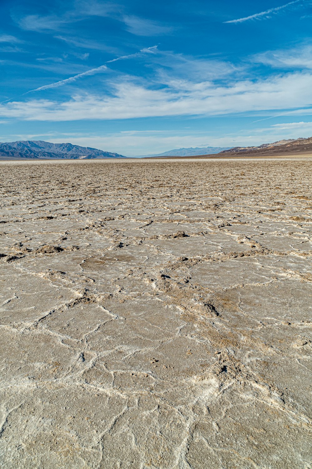 gray sand under blue sky during daytime