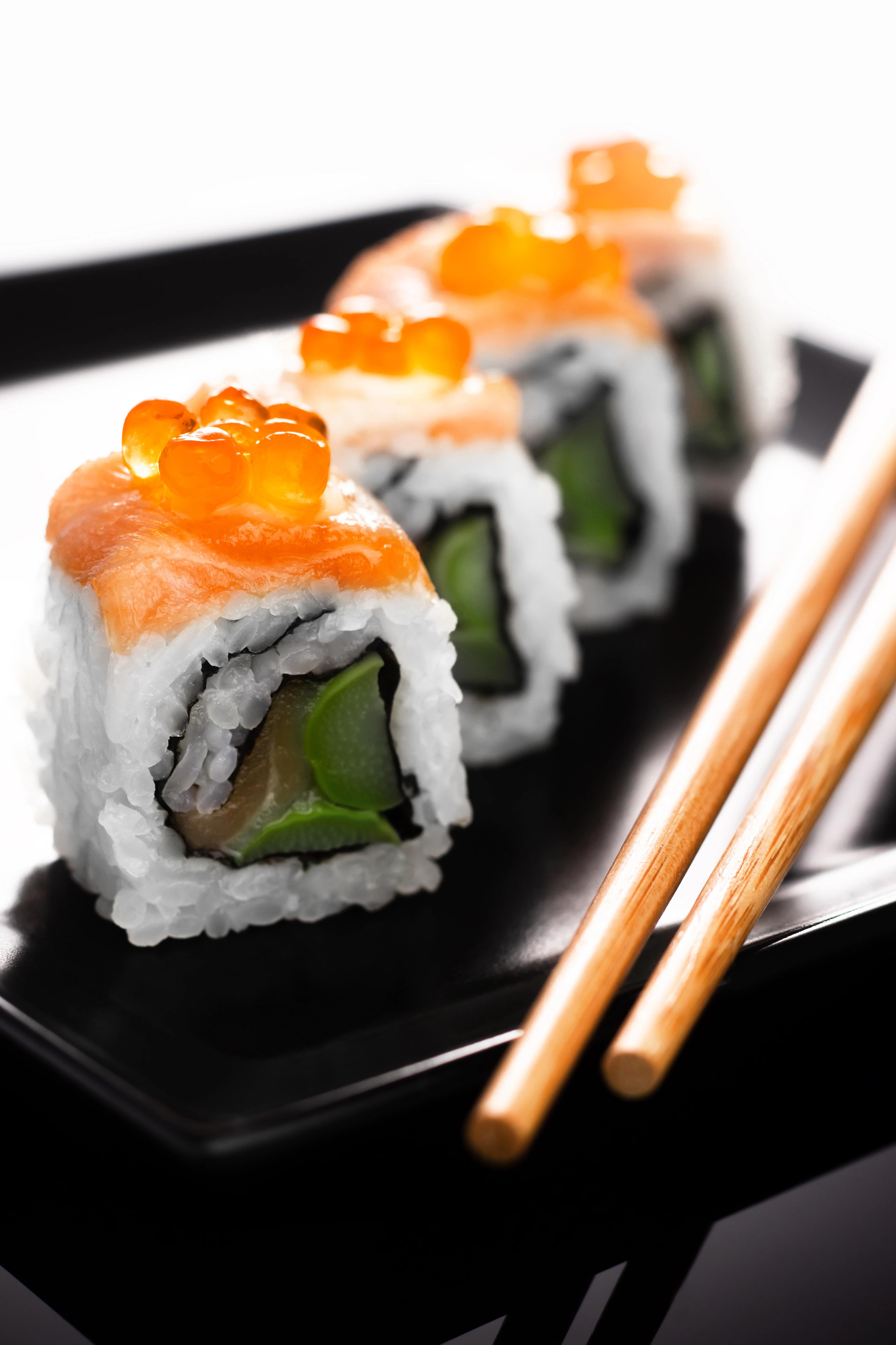 A sushi roll close-up on a dark plate