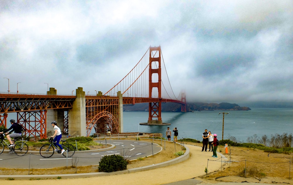 people walking on gray concrete bridge during daytime