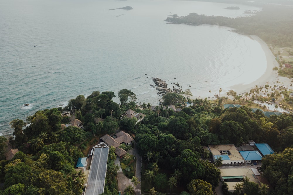 aerial view of houses near body of water during daytime