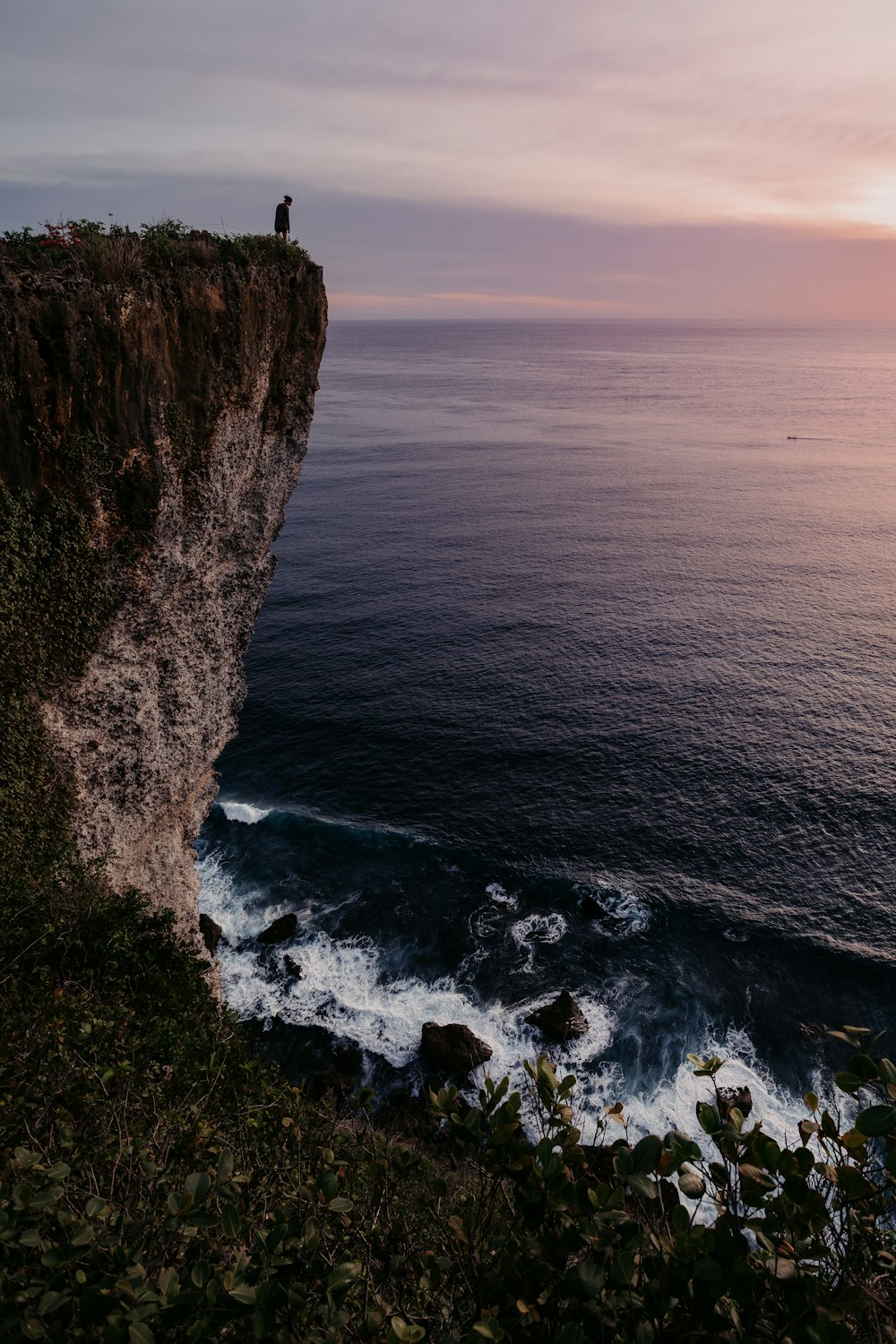 brown rock formation beside body of water during daytime