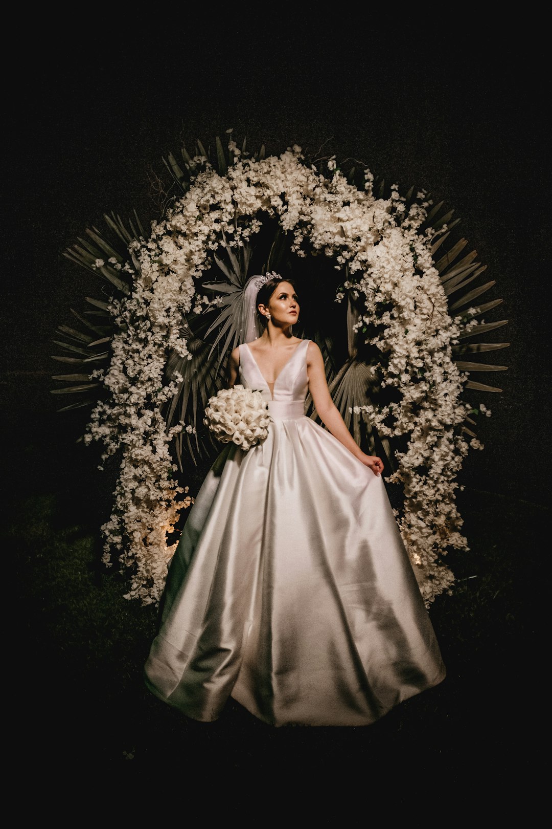 woman in white dress holding bouquet of flowers