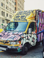 Vehicle wrap with eye-catching designs parked in a city street.