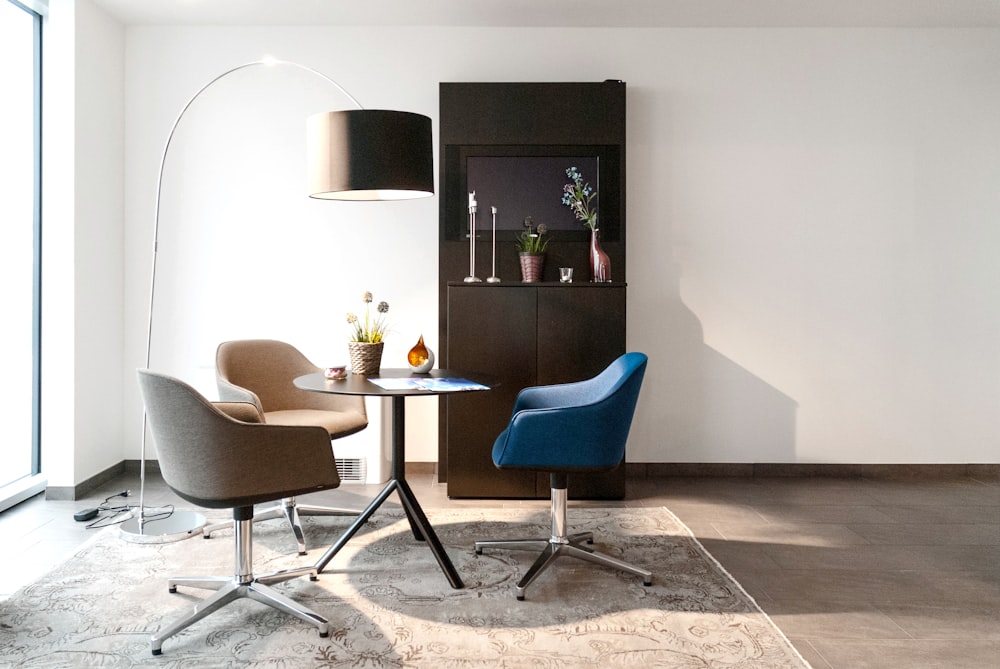 black wooden table with blue padded chair