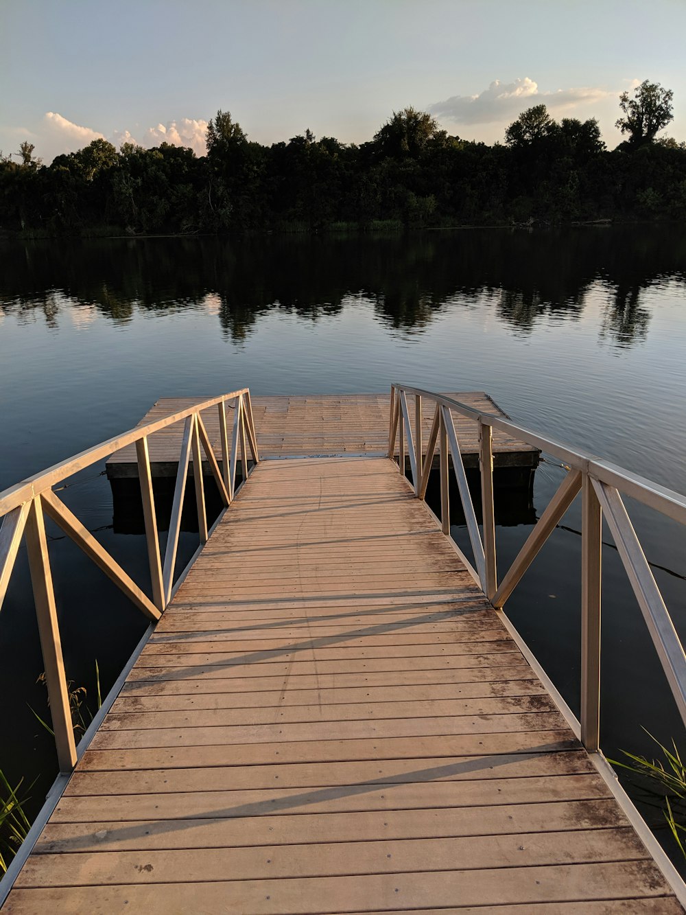 brown wooden dock on lake during daytime