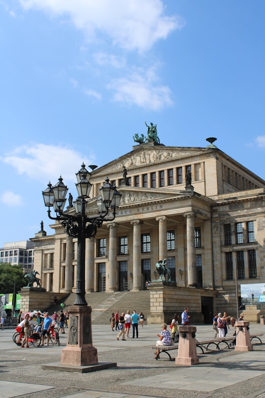 people walking around brown concrete building during daytime in Konzerthaus Berlin Germany