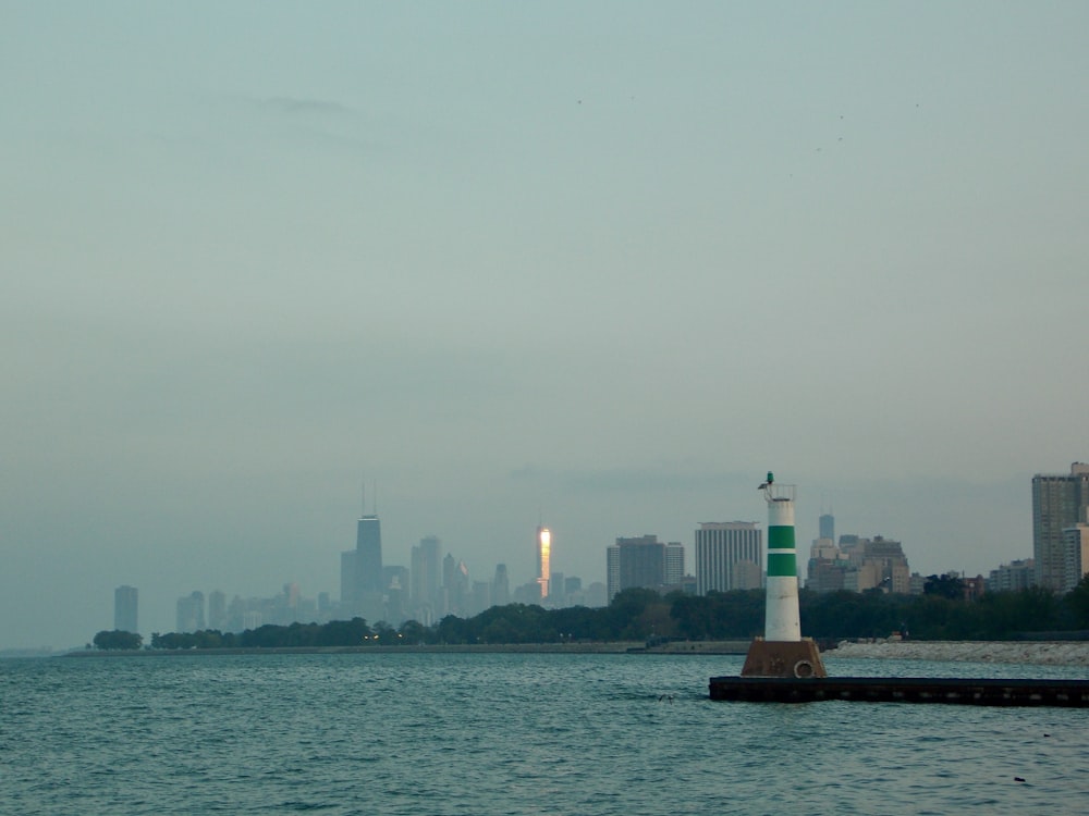 white lighthouse near body of water during daytime