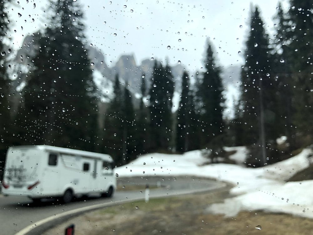 white and gray rv trailer on snow covered ground