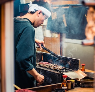 man in blue long sleeve shirt cooking