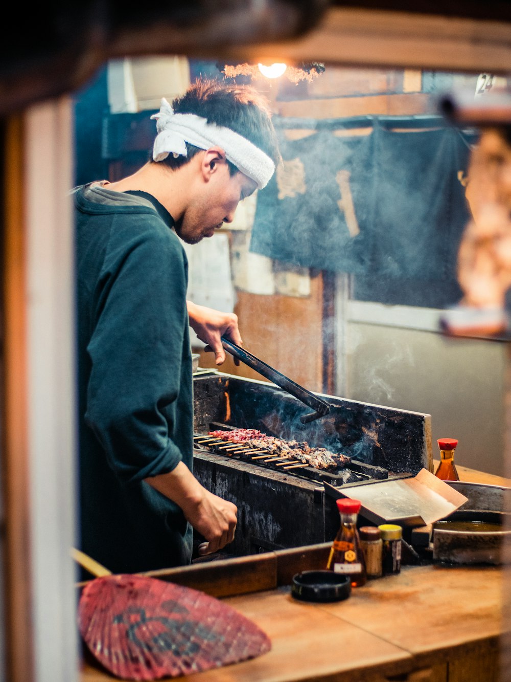 man in blue long sleeve shirt cooking