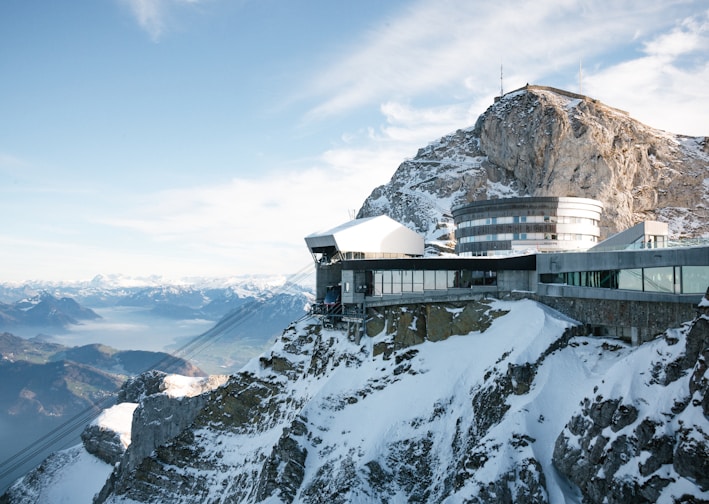 white and brown house on top of mountain