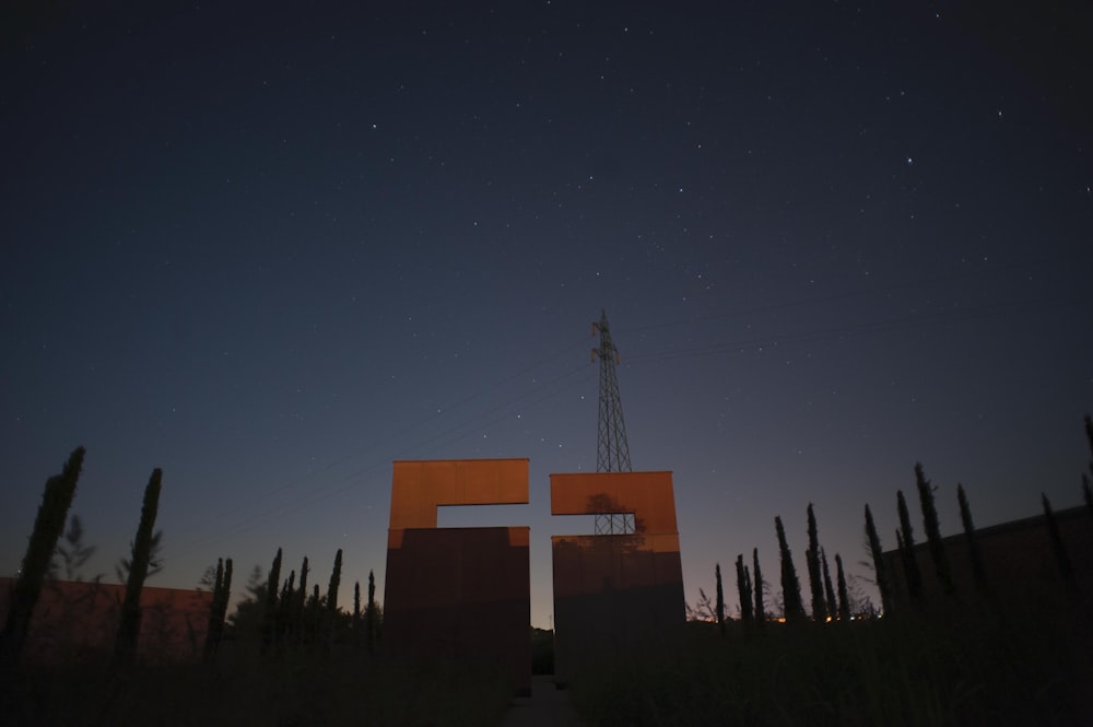 brown and white cross under blue sky during night time