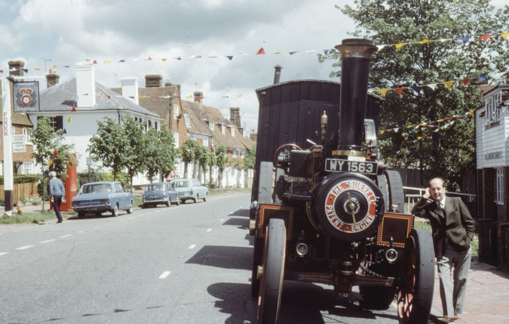 red and black vintage car on road during daytime