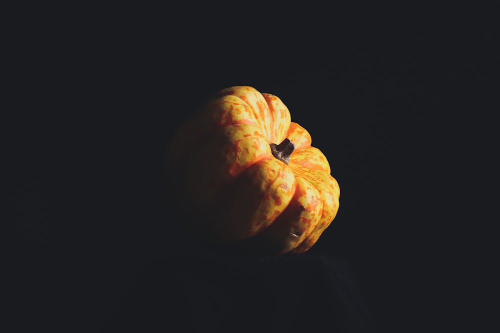 orange pumpkin on black background