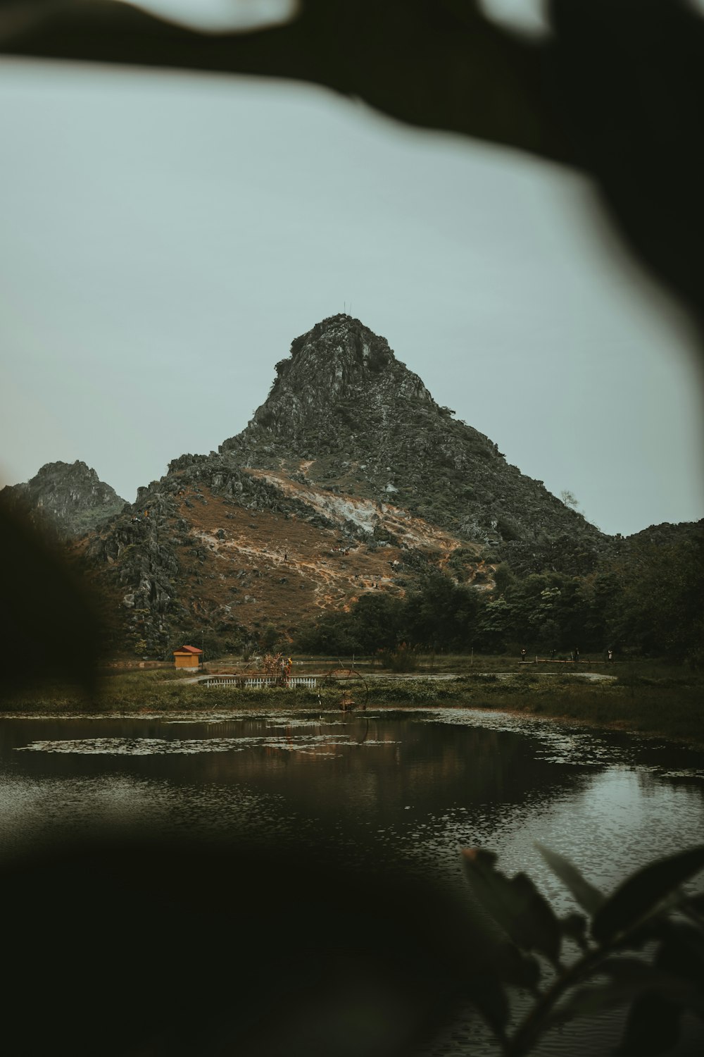 body of water near mountain during daytime