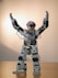 gray robot action figure on brown wooden table