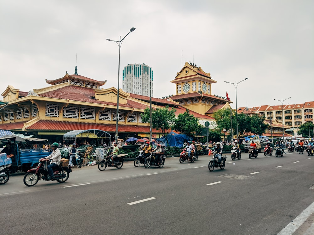 people riding motorcycle on road during daytime